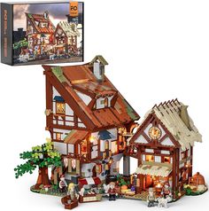 a toy house is shown with its lights on and it's contents in the box