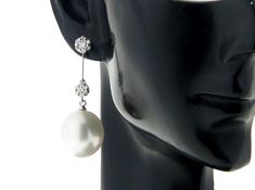 Classy dangle earrings, made of 18k solid white gold with 0.500ct sparkling genuine natural diamonds & 2 natural white, genuine south sea cultured pearls from Australia. Each of the Top grade Fine Drop shape, genuine south sea white pearl exhibits excellent high luster, thicker nacre with silky smooth and clean surface. Style: Dangle. Metal Purity: 18k Solid White Gold. Genuine Diamonds: 28 pcs / 0.500ctw. Earring Weight: Pearl Type: Genuine South Sea Cultured Pearl. Pearl Origin: Broome; We Elegant Platinum Dangle Bridal Earrings, White Platinum Dangle Diamond Earrings, Elegant Platinum Dangle Earrings, Elegant White Platinum Bridal Earrings, Exquisite White Platinum Earrings, Elegant Platinum Diamond Earrings, Elegant Platinum Drop Earrings, Elegant White Platinum Earrings, White Drop Diamond Earrings With Brilliant Cut