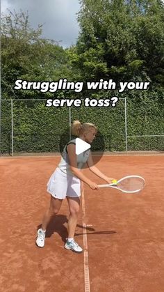 a woman holding a tennis racquet on top of a tennis court with the words struggling with your serve toss?