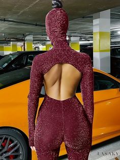 the back of a woman's body is shown in front of an orange car