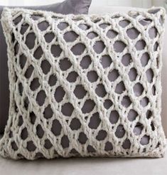 a crocheted pillow sitting on top of a couch