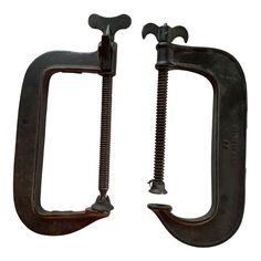 two metal hooks with screws attached to them