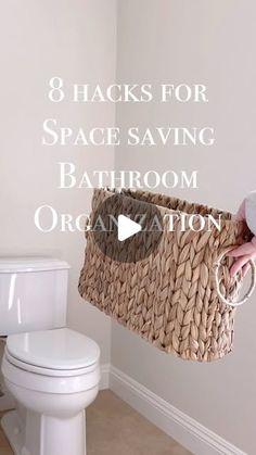 a person holding a basket over a toilet with the words 8 hacks for space saving bathroom organization