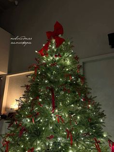 a christmas tree with red bows and lights