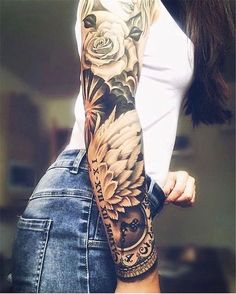 a woman's arm with flowers and an owl tattoo on her left arm, which is half sleeve