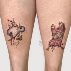 two legs with tattoos on them and one has a cat in the chair tattoo design