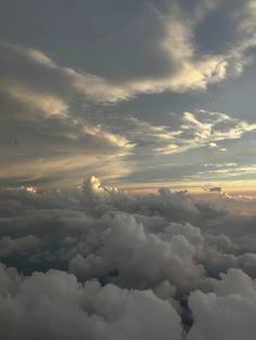 the sky is filled with clouds as the sun goes down in the distance behind it