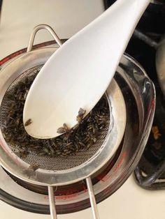 a white spatula is being used to stir up some food in a saucepan