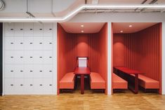 an empty room with red benches and white walls