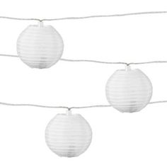 three white paper lanterns hanging on a string