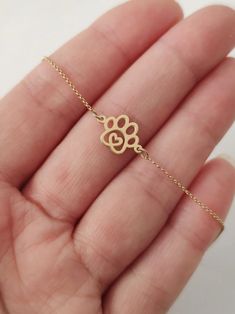 Tiny Dog Paw Print Bracelet 9K 14K Solid gold bracelet | Etsy Adjustable Paw Print Jewelry Gift, Adjustable Paw Print Jewelry As Gift, Adjustable Paw Print Jewelry For Gift, Gold Sterling Silver Jewelry With Paw Print, Gold Paw Print Jewelry For Best Friend Gift, Gold Paw Print Jewelry For Best Friend, Gold Paw Print Jewelry For Mother's Day, Gold Sterling Silver Heart Bracelet For Friendship, Gold Jewelry With Paw Print For Anniversary