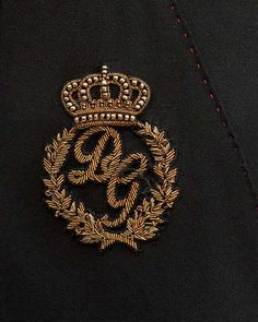 a black jacket with a gold emblem on it