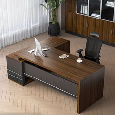 an office desk with a laptop on it