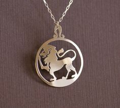 "The Lion This design was hand cut from a sheet of solid .925 sterling silver using a jeweler's saw. It measures 1 7/16\" x 1 1/8\" (3.65cm x 2.86cm) and is 0.66mm thick. Topped by the glyph of Leo, this pendant will hang from a sterling silver necklace of your length choice. All of our jewelry comes in a gift box ready for giving. A simpler Leo pendant can be found here: https://www.etsy.com/listing/578578100/leo-hand-cut-sterling-silver-glyph" Symbolic Silver Jewelry With Laser Engraving, Symbolic Silver Necklace With Laser Engraving, Symbolic Silver Laser Engraved Jewelry, Symbolic Laser Engraved Silver Jewelry, Laser Engraved Sterling Silver Necklace, Laser Engraved Sterling Silver Jewelry, Sterling Silver Medallion Necklace Laser Engraved, Symbolic Etched Sterling Silver Jewelry, Sterling Silver Laser Engraved Pendant