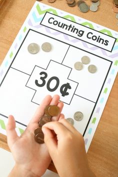 a person counting coins on a table with a sign that reads, counting coins $ 30