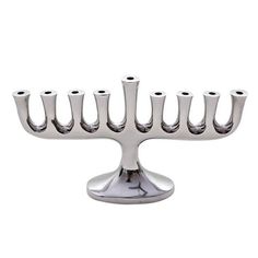 a silver metal menorah with eight candles on it's side and four holes in the middle