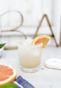 a grapefruit cocktail garnished with an orange slice