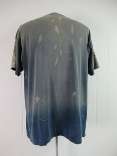 "Vintage 1980s blue cotton sports t shirt with white and yellow graphics. Eggleston's Softball Complex Champions. Has distressed paint all over and very sun faded. Size XL. Actual measurements are: 47\" around the chest 47\" at the waist 21.5\" shoulder seam to shoulder seam 29\" overall length" Faded Pre-washed Cotton T-shirt, Vintage Faded T-shirt Pre-washed, Pre-washed Short Sleeve Tops For Summer, Pre-washed Crew Neck Graphic Tee, Vintage Acid Wash Pre-washed T-shirt, Vintage Pre-washed T-shirt For Summer, Distressed Cotton Crew Neck T-shirt, Faded Distressed Crew Neck T-shirt, Faded Distressed T-shirt With Relaxed Fit