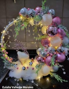 a christmas wreath made out of balloons and ornaments