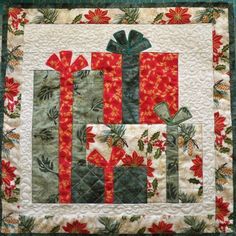 a quilted wall hanging with presents on it