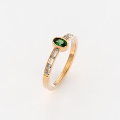 The Bezel Set Vintage Emerald Ring is a timeless expression of elegance and classic beauty. Crafted in 14k Solid Gold, this small oval engagement ring showcases a deep green emerald gemstone in a bezel setting. This ring embodies understated charm, making it an ideal choice for women who appreciate the simplicity and allure of emerald gemstones. Ring Features * 14k Solid Gold (also in 10k,18k ) * Band Options; Yellow Gold, White Gold Rose Gold * Top Width: 6.08x4.23 mm * Band Width: 1.51 mm * Th Elegant Oval Diamond Ring With Baguette Diamonds, Oval Yellow Gold Ring With Baguette Diamonds, Timeless Oval Diamond Ring With Baguette Accents, Timeless Oval Diamond Ring With Baguette Diamonds, Timeless Oval Ring With Baguette Diamonds, Timeless Oval Rings With Baguette Diamonds, Oval Rings With Baguette Diamonds In 14k Gold, Classic Oval Diamond Ring With Baguette Diamonds, Oval 14k Gold Rings With Baguette Diamonds