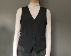 Vintage dark blue white double-striped dotted lines vest/ Unisex waistcoat/ Formal Fitted Classic Romantic Vest/ Fully lined/ Pockets Vintage dark blue and white stripped outside, black fabric inside. Decorative metal buckle on the backside. Materials: 72% polyester, 25% viscose, 3% elastane Labeled size: 42 EU (XL) Measured flat: Back Length : 20.1'' / 51cm Front Length : 23.2'' / 59cm Shoulder to shoulder: 12.6'' / 32cm Bust // chest (from armpit to armpit): 18.5'' / 47cm No rips, holes or stains. Perfect for the holidays!! #JZ13 Vintage Blue Sleeveless Outerwear, Striped Waistcoat, Pinstripe Tailored Sleeveless Vest, Vintage Blue Sleeveless Vest, Chic Striped V-neck Vest, Women Waistcoat, Scandinavian Dress, Elegant Vest, Black Leather Vest