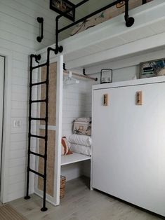 a white refrigerator freezer sitting inside of a kitchen next to a dryer and towel dispenser