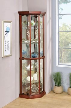 a corner display case with glass doors and wood trim