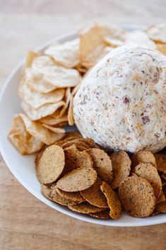 a white plate topped with chips and a cheese ball