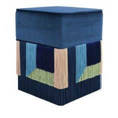 a blue stool with multicolored fringes on it