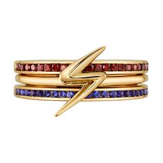 three stacking rings with multicolored stones and a gold - plated hook