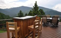 a hot tub sitting on top of a wooden deck next to a table and chairs