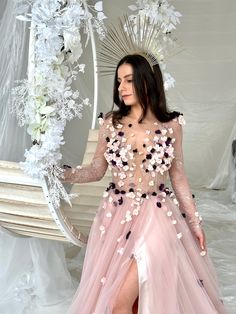 a woman in a pink dress with flowers on it