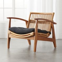 a wooden chair sitting in front of a window