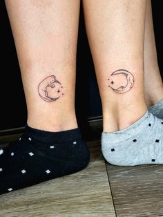 two people with matching tattoos on their legs, one has a cat and the other has a fish