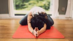 a woman laying on top of a yoga mat with the words yoga up of the week