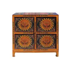 an orange and black cabinet with four drawers on it's sides, decorated with colorful designs