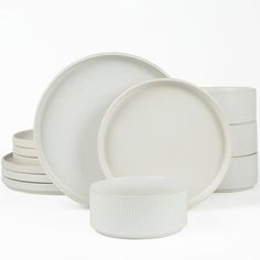 white dishes are stacked on top of each other