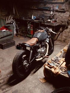 a motorcycle parked in a garage next to other tools