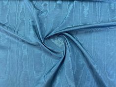 the fabric is very soft and shiny in this blue color, it looks like something out of