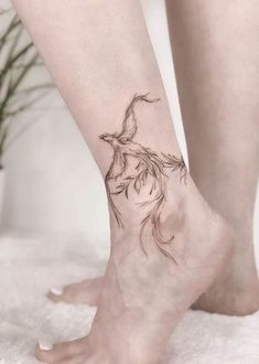 a woman's foot with a tattoo on it