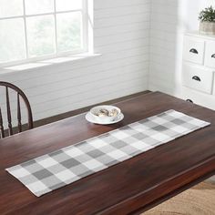 a dining room table with a place mat on it and a bowl of food in the middle