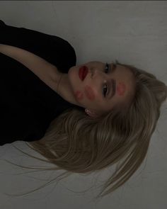 a woman with long blonde hair laying on the floor