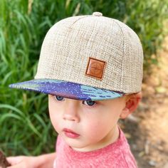 "For your adventure-loving little wanderer, our \"San Blas\" kid's and toddler hat is adorned with a small, brown compass patch on a light linen hat with a custom print floral fabric on it's flat brim. This one is super special and is the perfect back to school accessory. ~ Mid-profile kid's trucker cap ~ Brown compass patch, with linen cap and a floral print flat brim. ~ Adjustable snapback closure lets you personalize your fit ~ Cotton / Linen / Leather ~ Two sizes; Made for kids; Imported Tee Hats For Kids, Baby Sun Hat, Printed Flats, San Blas, School Accessories, Toddler Hat, Jan 20, Cute Hats, Kids Hats