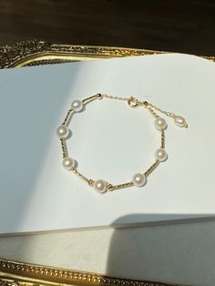 Welcome to PearlologyBoutique! This is a high quality thick nacre fresh water pearl bracelet, with 18k gold plated accessories adjustable chain. You will love this shiny unique design bracelet. A simple design that you can wear in any occasion.  Pearls are unique and rarely perfect. Sometimes they will have slight imperfections, small blemishes or irregular shapes. **handmade jewelry** **Warranty** We do understand that handmade jewelry can be delicate, that's why we are offering a 30-day warranty for your purchase. If your item has a manufacturing defect or broken during this time frame, please contact us and we will offer free repair for you. Please note we are not responsible for normal wear and tear or failure to adhere to the care instruction on the jewelry. Some of the items can be c Fresh Water Pearl Bracelet, Irregular Shapes, Design Bracelet, Freshwater Pearl Bracelet, Fresh Water Pearl, Wedding Bracelet, Gifts Holiday, Bracelet Designs, Pearl Bracelet