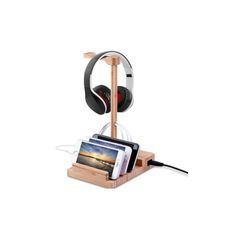 a wooden charging station with headphones and a cell phone on the side, in front of a white background