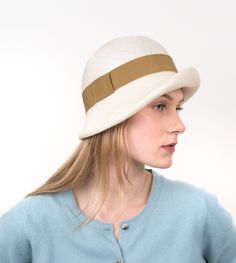 "Aimee" is a light and airy summer hat, inspired by the romantic look of the 20s. The fine braid (Parasisol) made of unbleached straw underlines the elegant shape of the cloche. The fine curve of the brim is emphasized by a wide hat band. The hat goes perfectly with light summer dresses made of flowing fabrics, but also with jeans and shirt. There are no limits to the pleasure of combining. Available in sizes 55 cm - 59 cm. Colour "cream white" Parasisol hat (plaited straw), with ochre hatband 6 Elegant Cream Toquilla Straw Hat Band, Cream Gatsby Style Hat, Adjustable Cream Gatsby Hat, Cream Adjustable Gatsby Hat, Spring Cloche Hat In Toquilla Straw, Elegant Natural Cloche Hat For Spring, Spring Toquilla Straw Cloche Hat, Elegant Beige Straw Cloche Hat, Classic Summer Cloche Hat