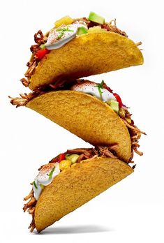 three tacos stacked on top of each other