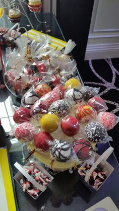 a table topped with lots of cupcakes covered in frosting and sprinkles