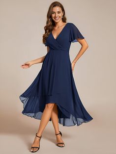 a woman in a blue dress posing for the camera